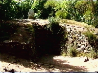 Entrance to Kercado tumulus and menhir on top